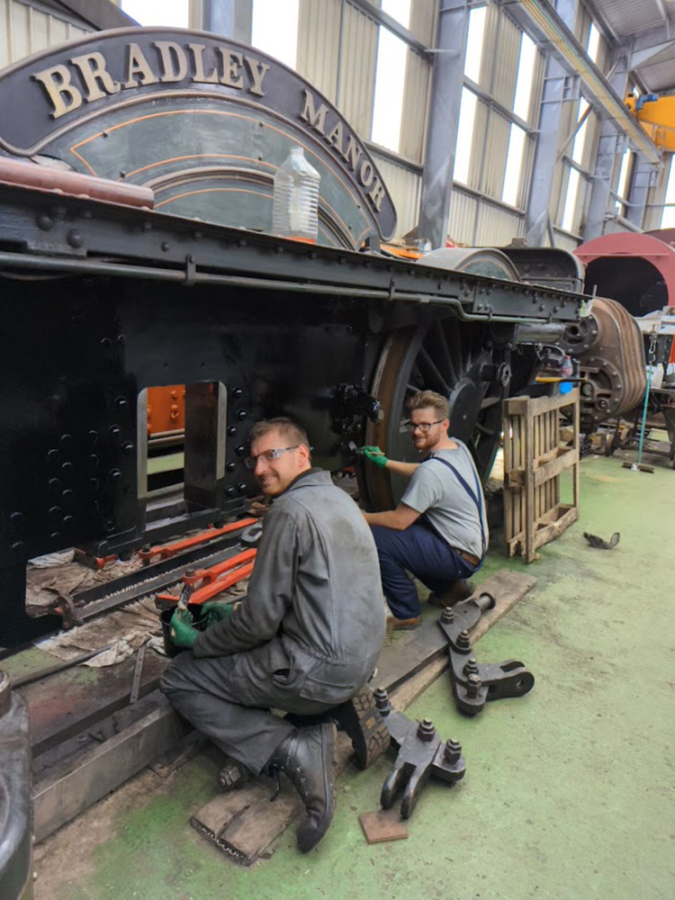 On 22nd July, trustee Chris Field and volunteer Ben Morris are seen happy in their work painting the frames in the space that the driving wheelset will occupy once replaced Photo: Paul Spence