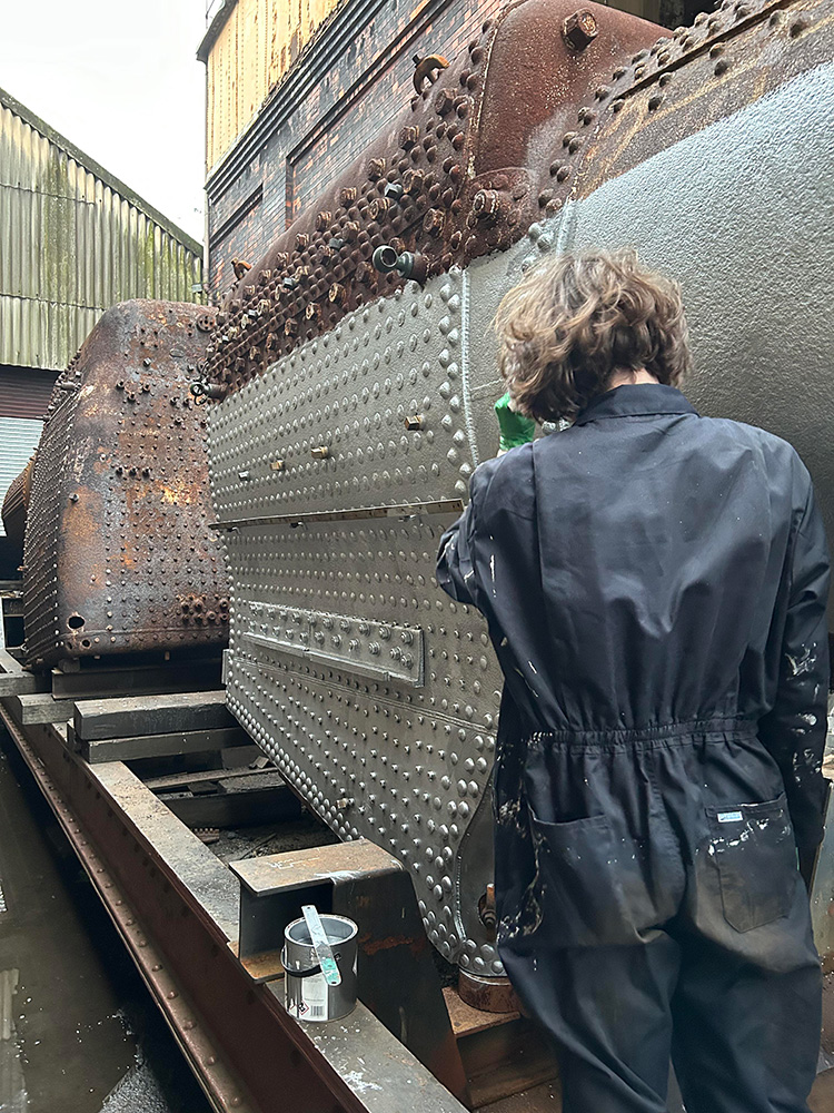 Here, volunteer Ewan Creese is seen at work improving the boiler’s appearance no end [Photo: Martin Creese]